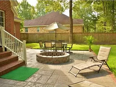 Photo of the back patio, fire pit and privacy fence of the private home for sale by owner in North Charleston, SC within the Coosaw Creek Country Club Community.