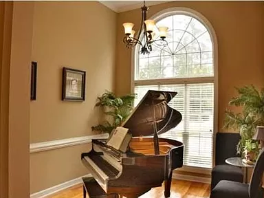 Picture of an elegant room with a piano in the house for sale by owner located in the Coosaw Creek Country Club subdivision in North Charleston, South Carolina.