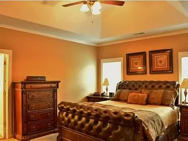 Photo of the master bedroom suite with a tray ceiling inside the homeowners house for sale in the Coosaw Creek Country Club Community located in North Charleston, SC  29420